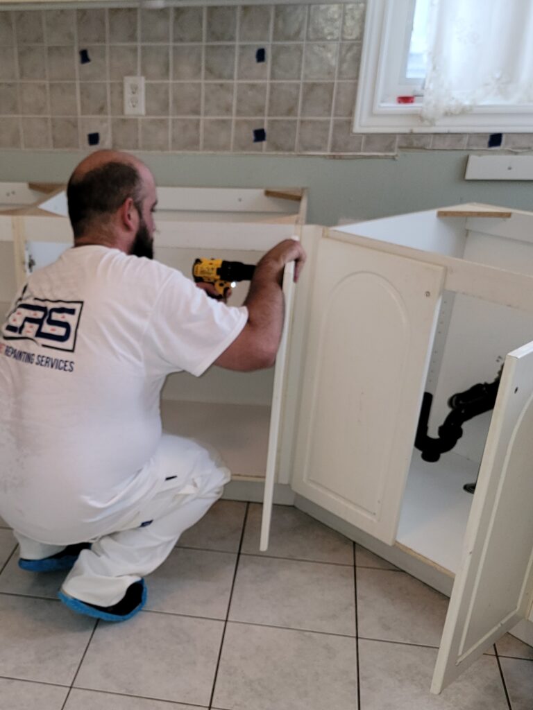 removing the doors and drawers on the first day of the cabinet painting process