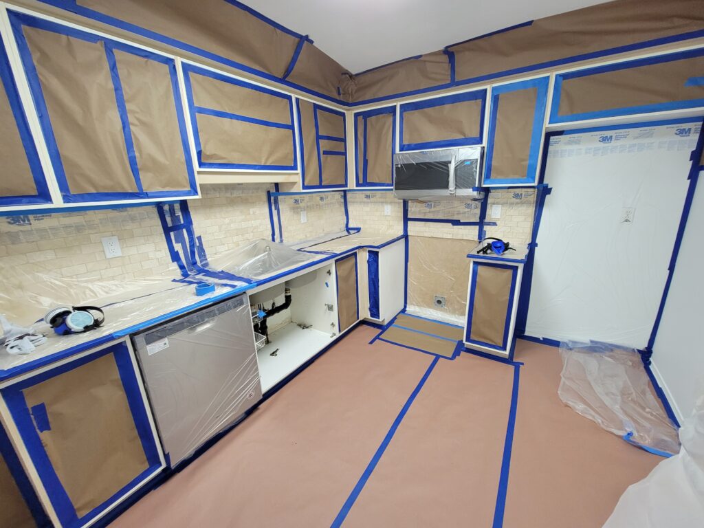 masking the kitchen on the first day of the kitchen cabinets painting process